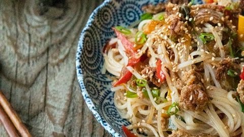 Easy Garlic Ginger Crispy Pork Noodles are going to be your new favourite dinner. Crazy simple. Crazier delicious. And easy on your pocketbook to boot. This delicious meal-in-one whips up in less than 30 minutes.